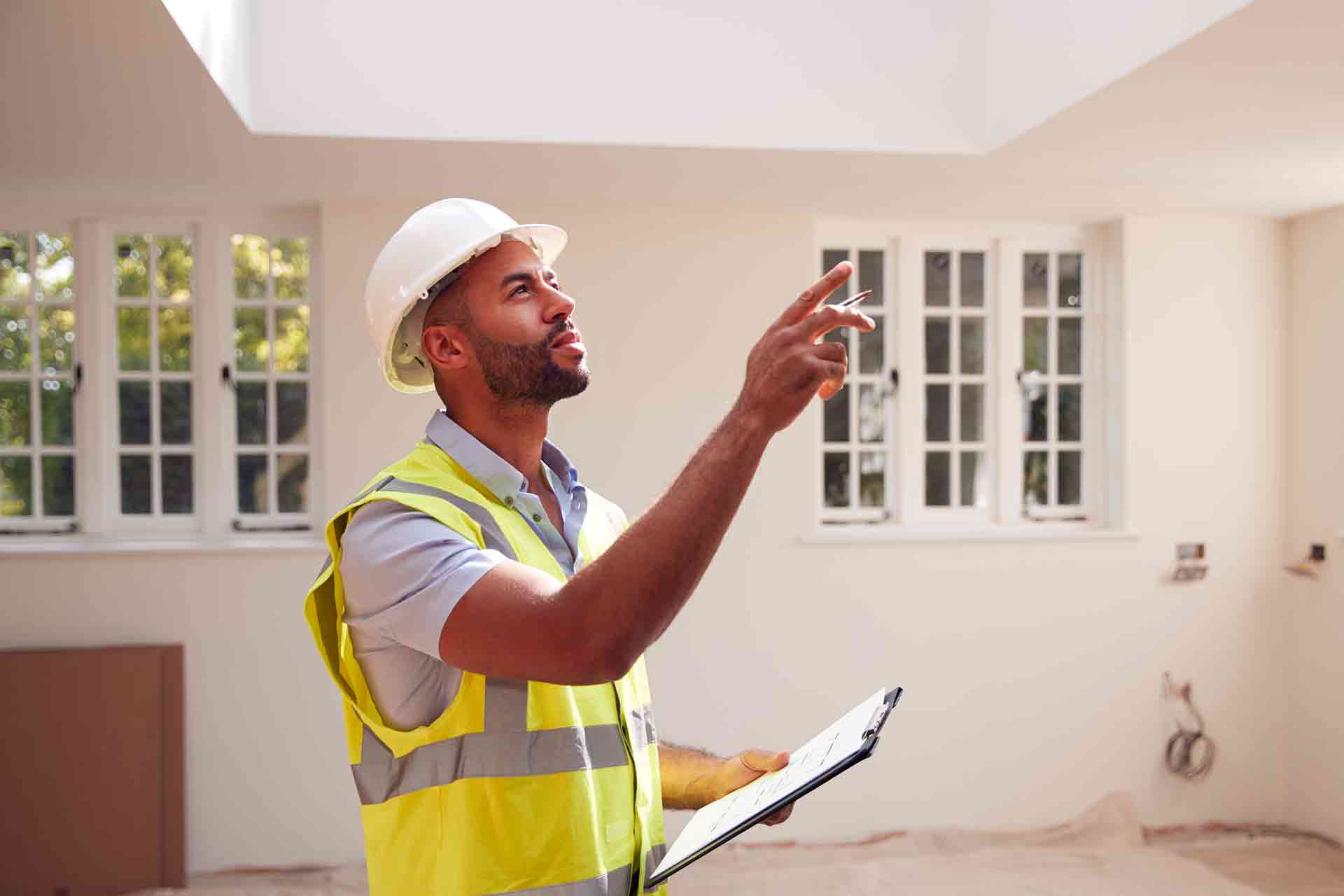 Third Party Wall Surveyors Gloucester reviewing plans between two parties during a dispute